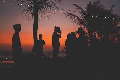 a group of people standing on top of a beach