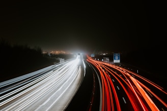 timelapse photography of traveling vehicle on road during nighttime