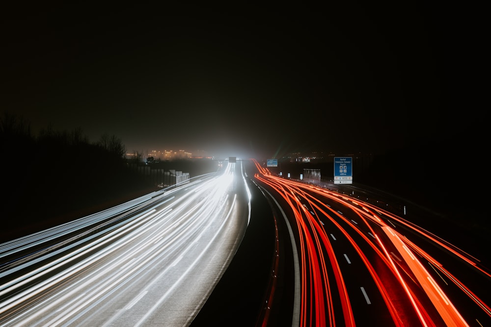 timelapse photography of traveling vehicle on road during nighttime