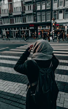 A traveler checking a map with a secure backpack in a bustling city street.