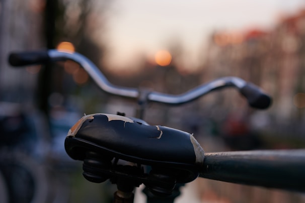 Close-up of trilux tricycle’s premium leather seat and polished metal frame under soft studio lighting