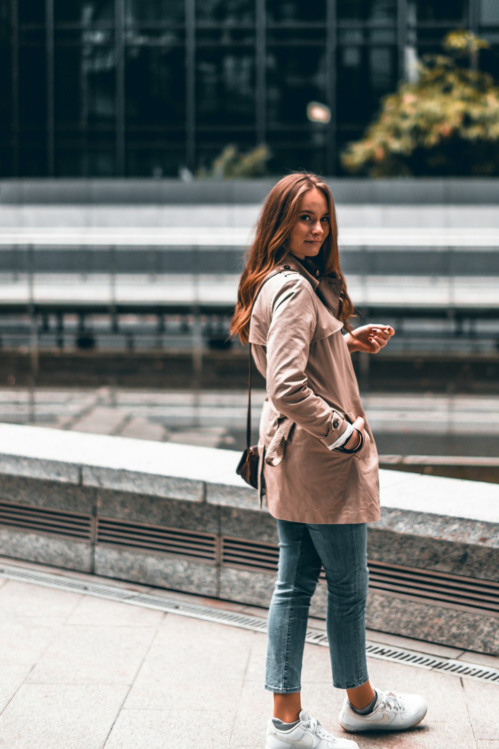 woman standing in front of gray concrete hump