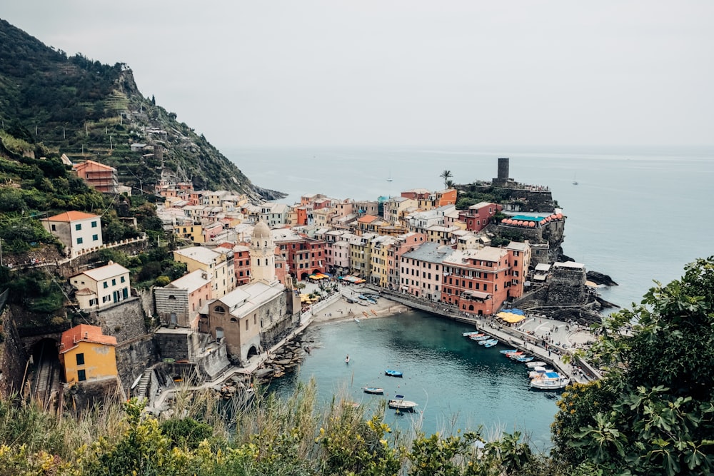 wide-angle photography of buildings beside seashore during daytime