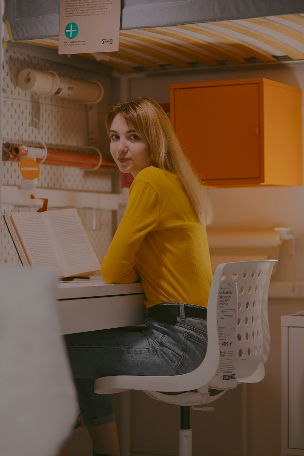 woman sitting in front of table reading book