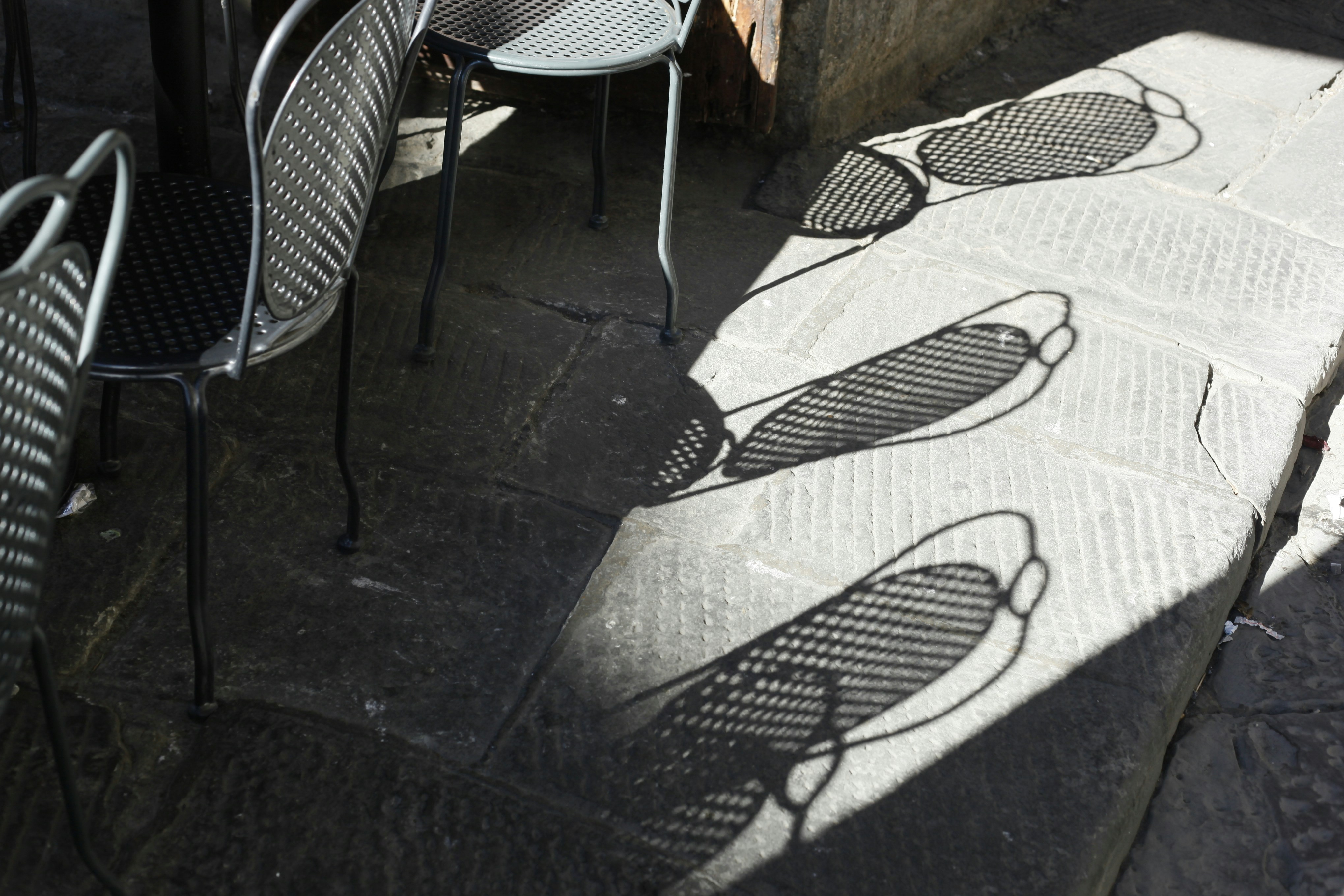 three gray metal patio chairs