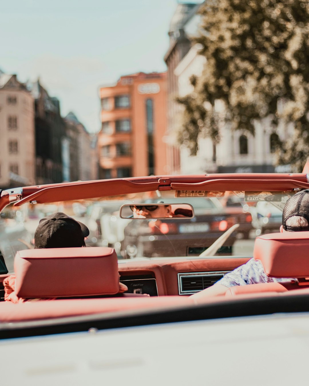 two person riding pink convertible