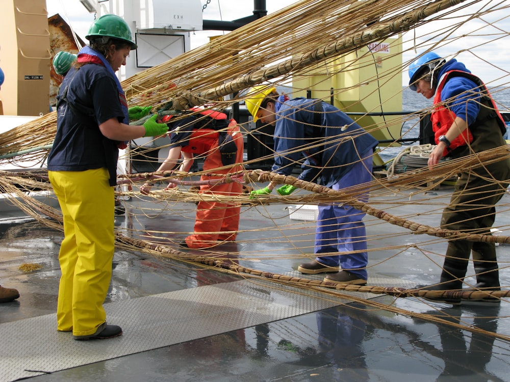 people working on brown rope