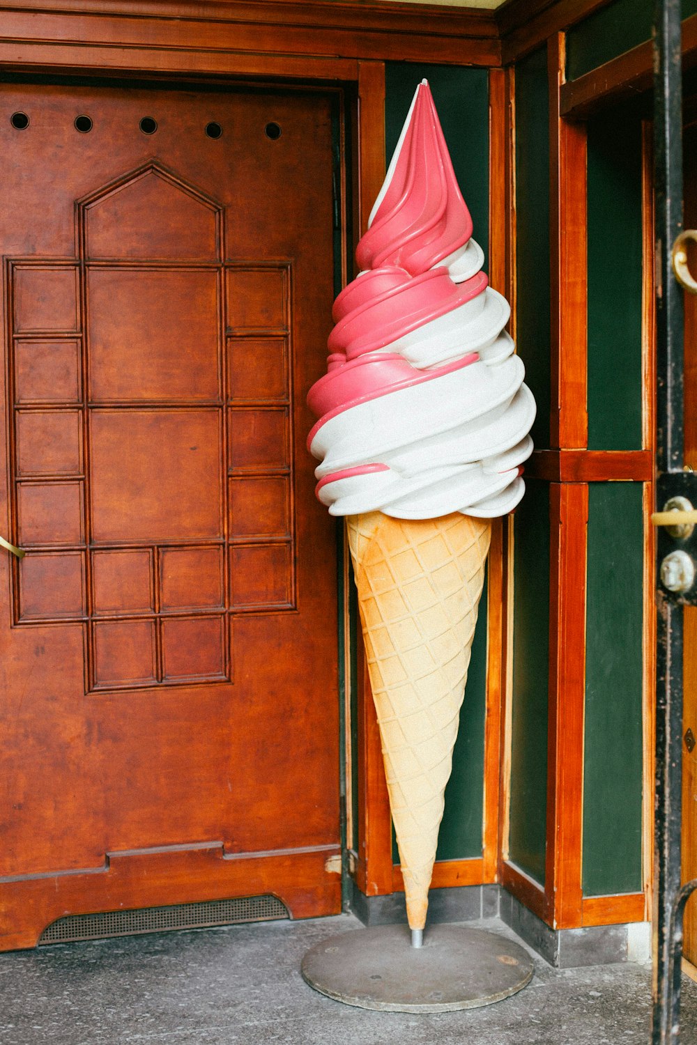white and pink ice cream cone stante