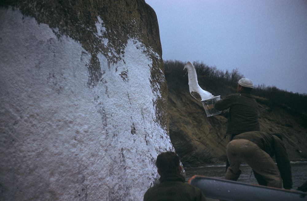 person pouring white paint