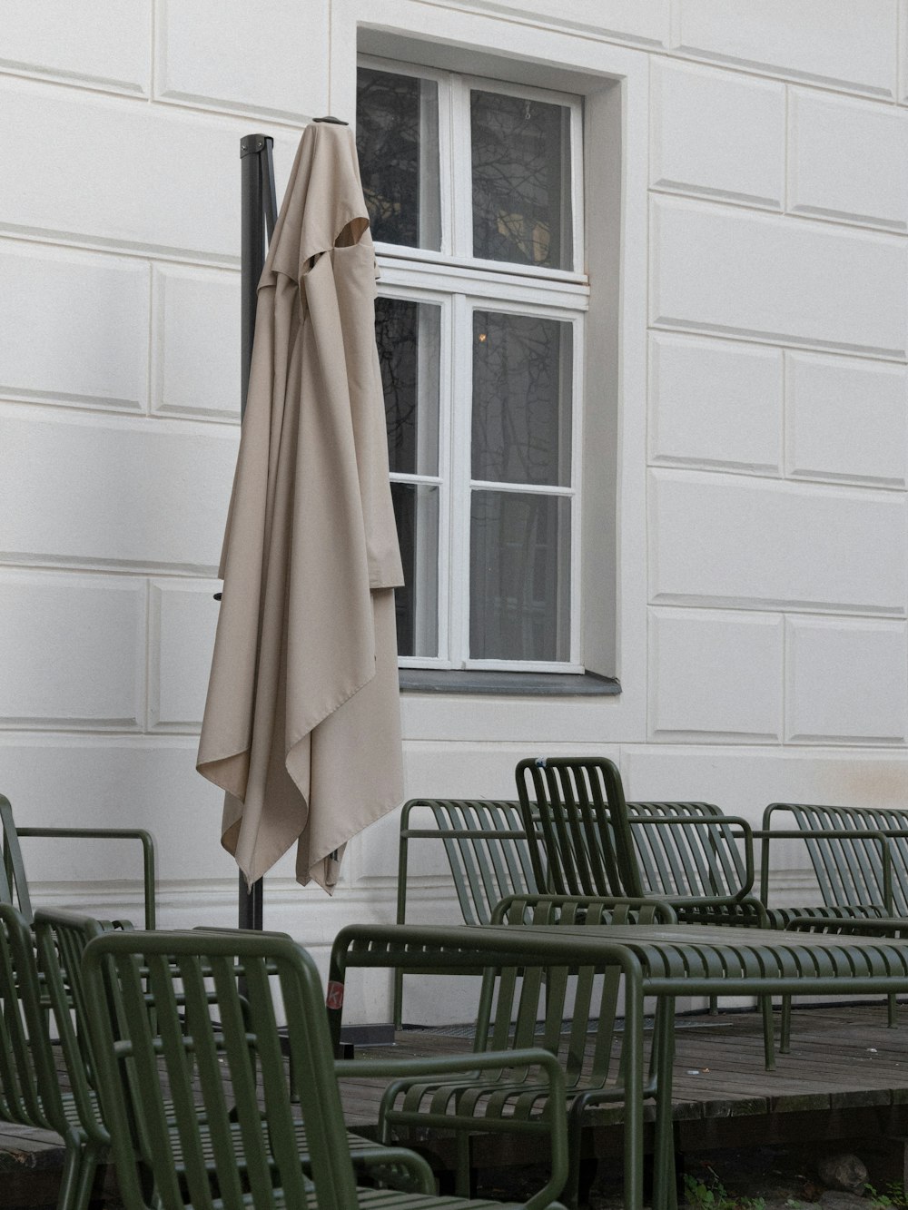 gray patio umbrella beside wall