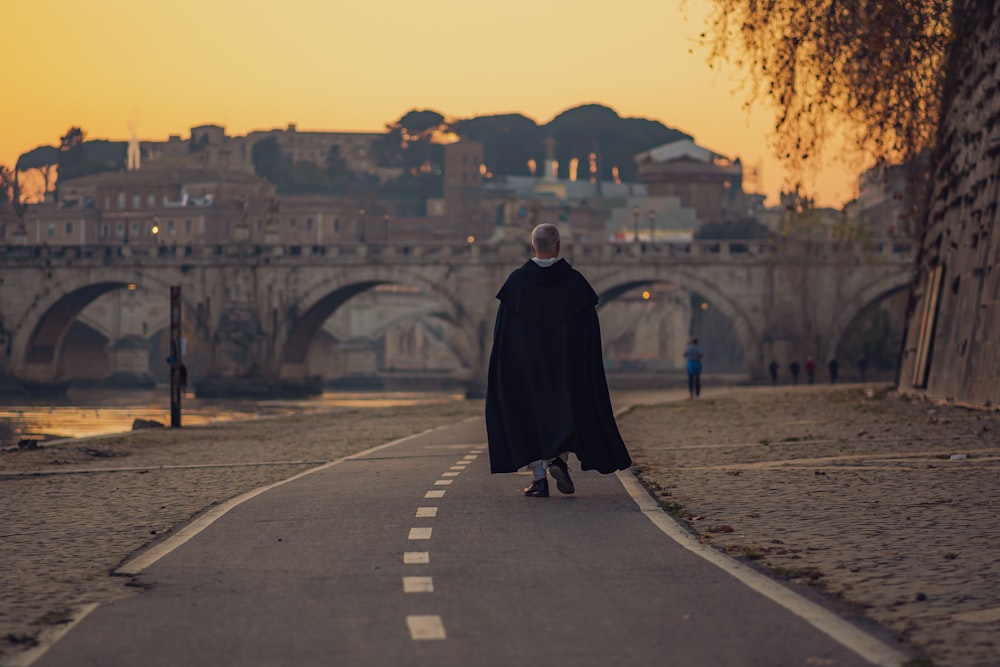 man walking on road