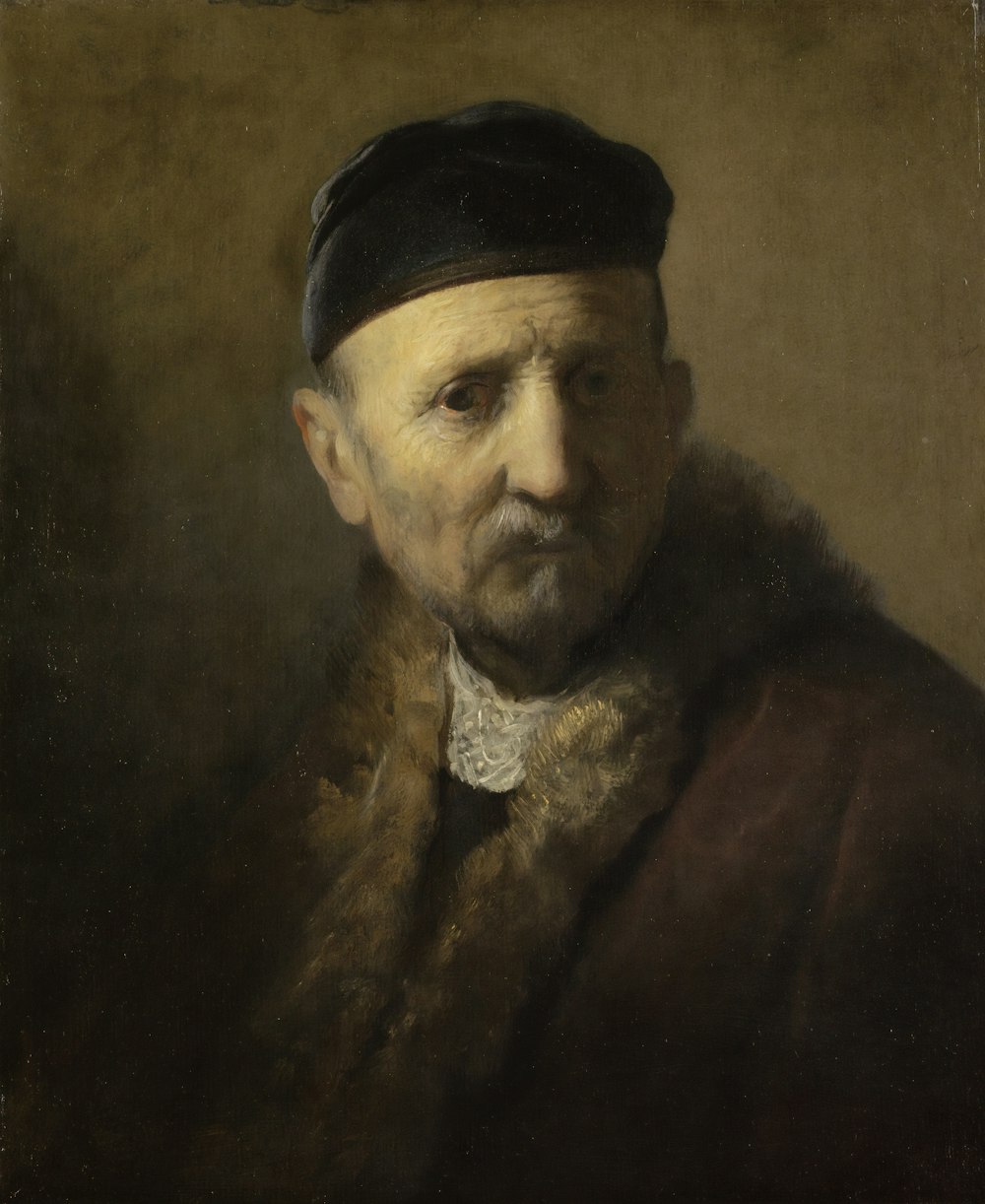 man in brown coat painting