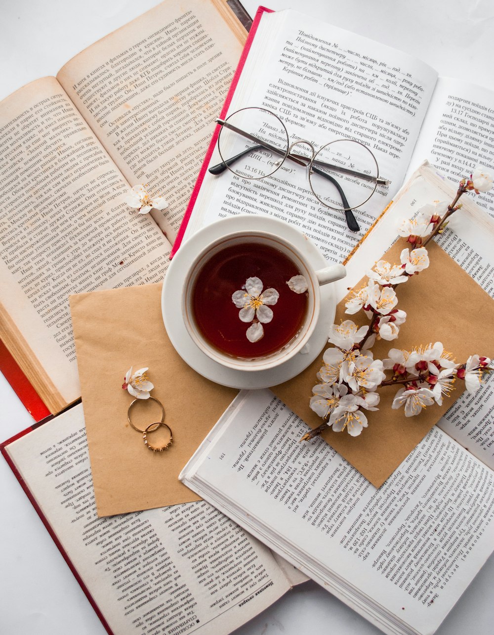 filled teacup on books