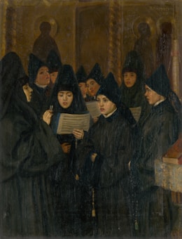 A group of women dressed in black religious garments stand together, holding and looking at hymn sheets. The background shows a dimly lit room with religious iconography.