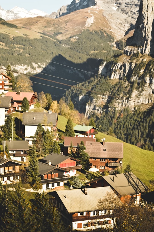 high-angle photo of brown and black houses beside mountain ranges in Lauterbrunnen Switzerland