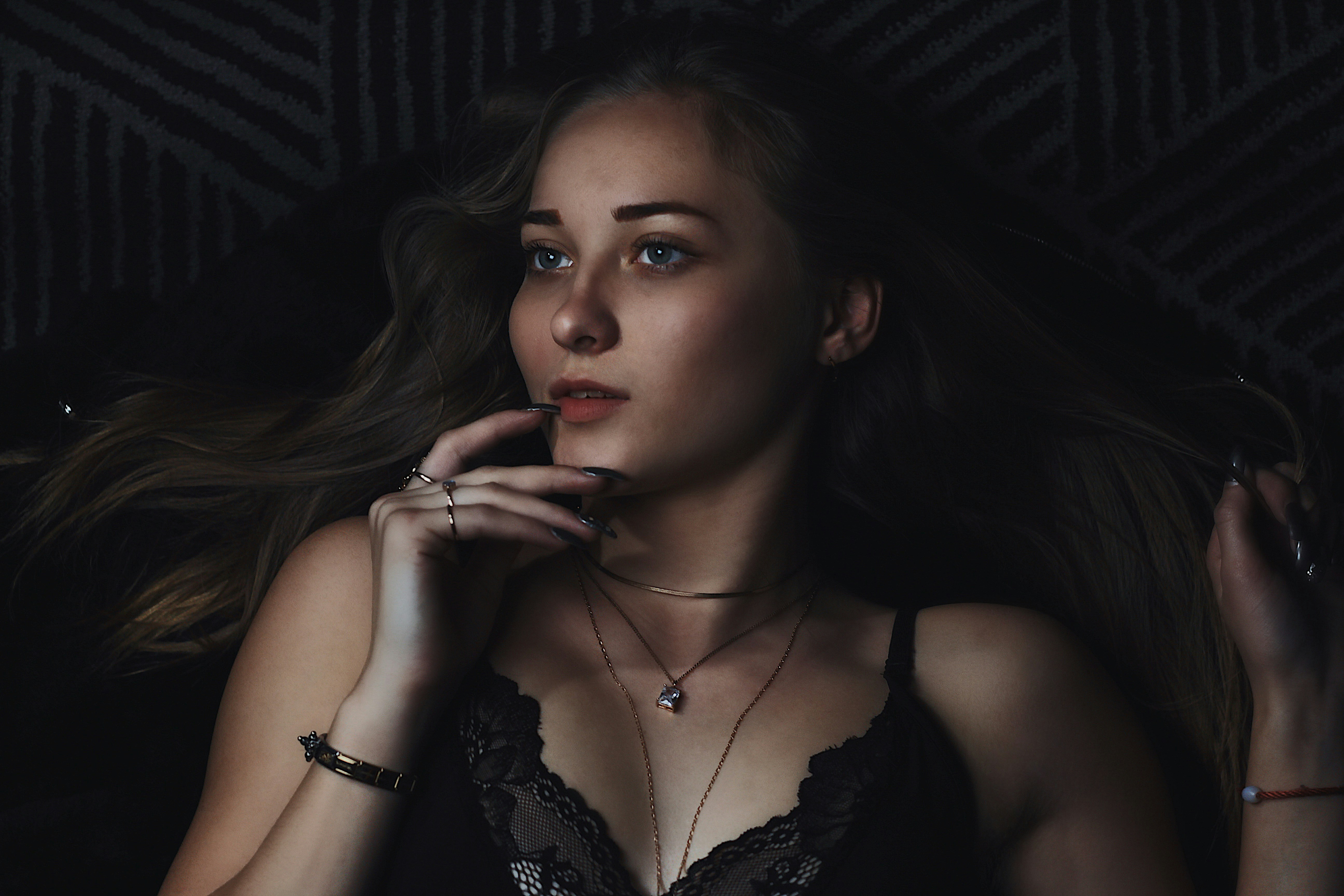 woman touching her lips wearing black lingerie