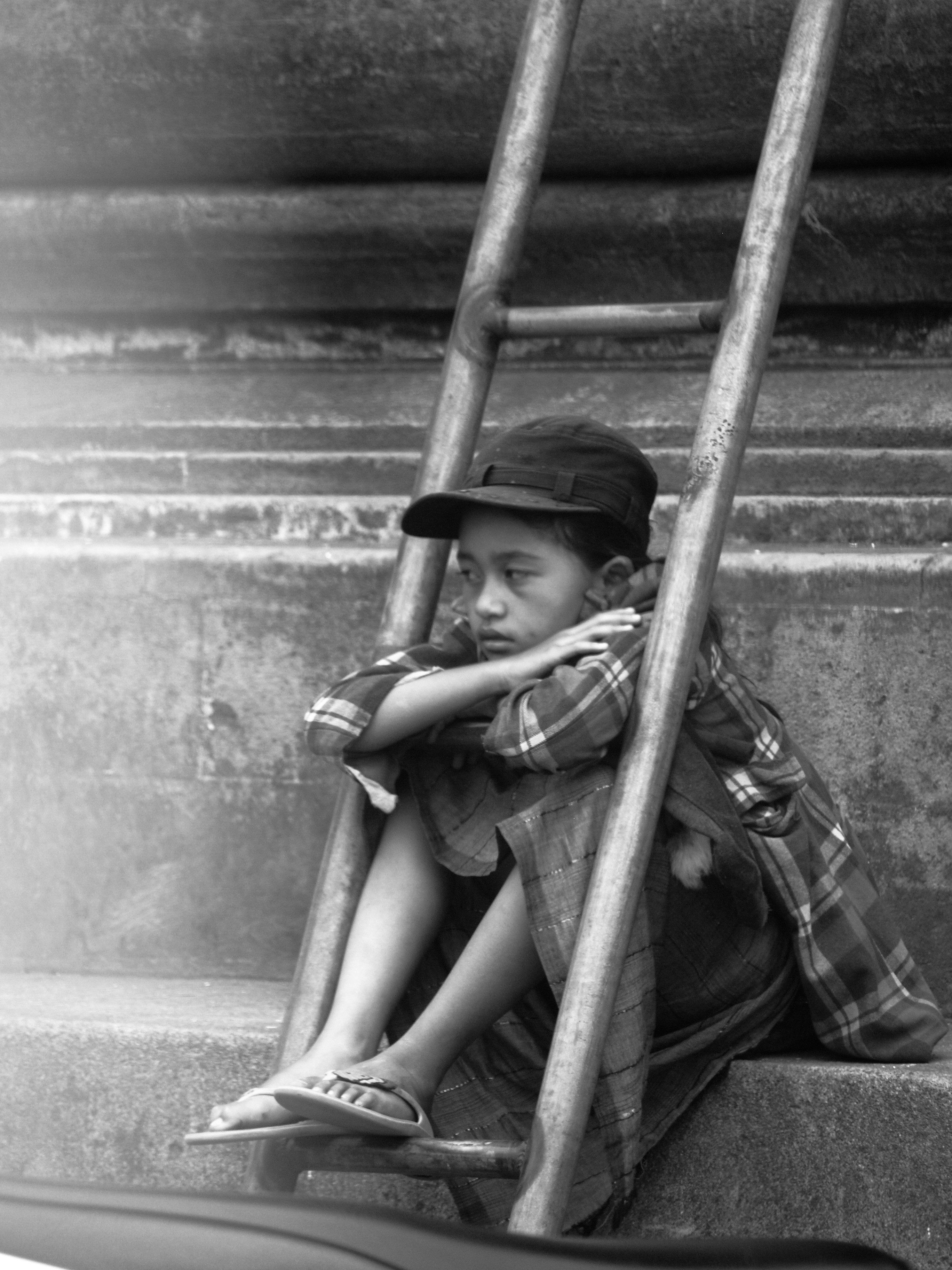grayscale photo of boy wearing black and white plaid top