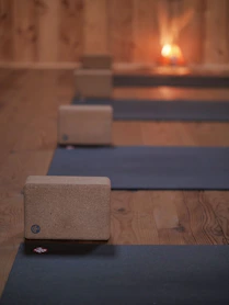 a row of yoga mats sitting on top of a wooden floor
