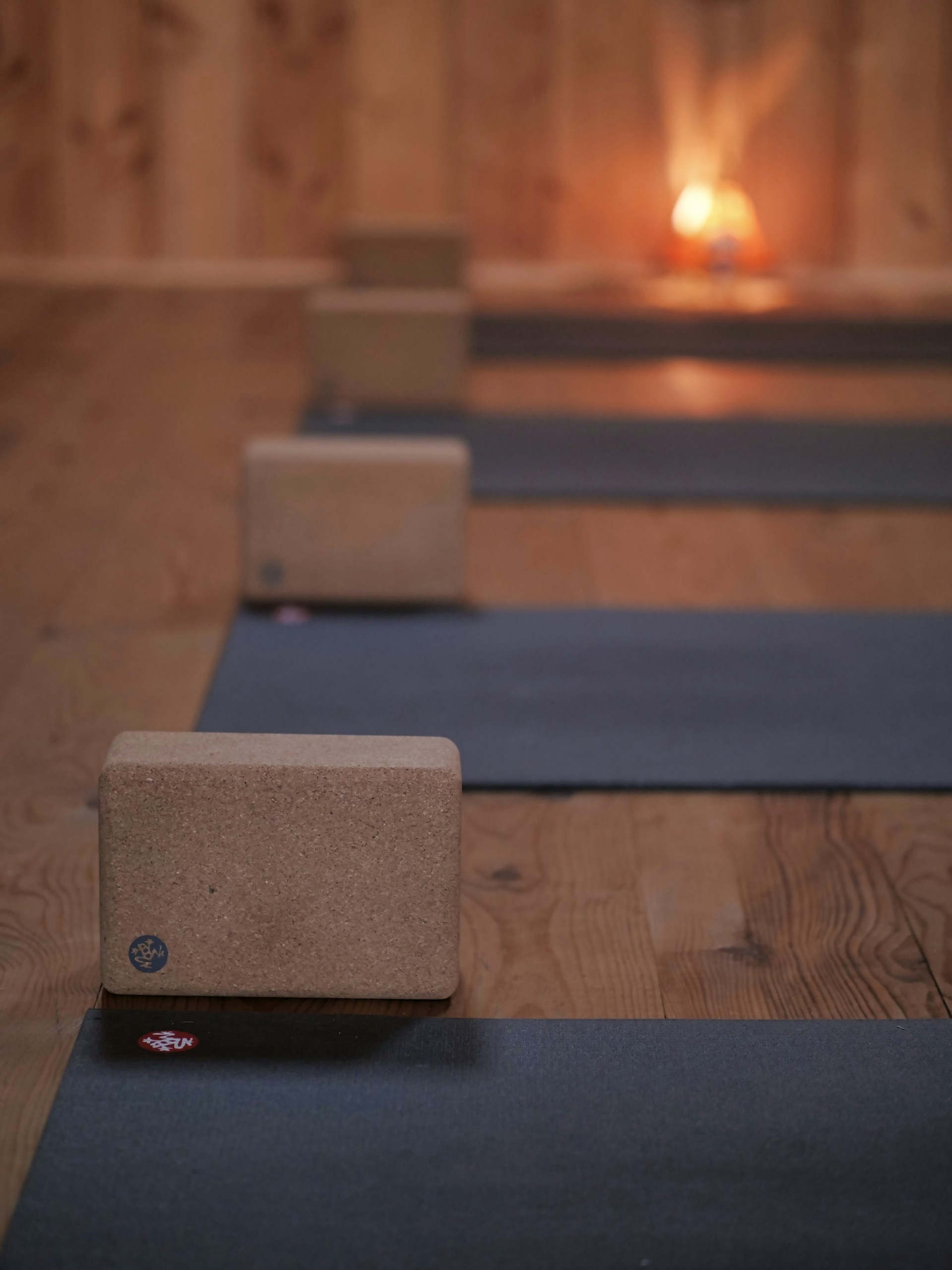 a row of yoga mats sitting on top of a wooden floor