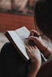 A close-up of hands holding a journal and pen during a session.