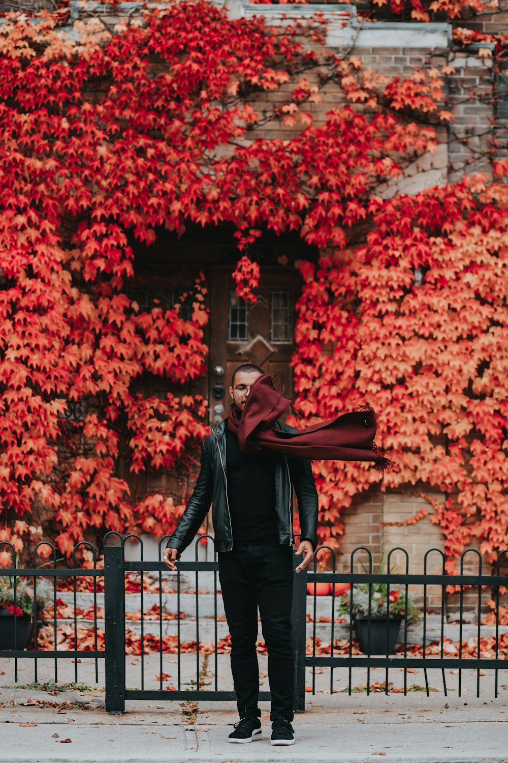 man standing near black fence