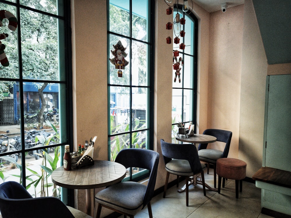 two round brown wooden tables and gray chairs set