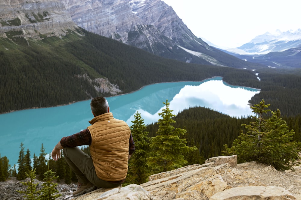 man sitting on rockk