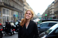 A candid street photo capturing a fleeting smile amidst urban bustle.