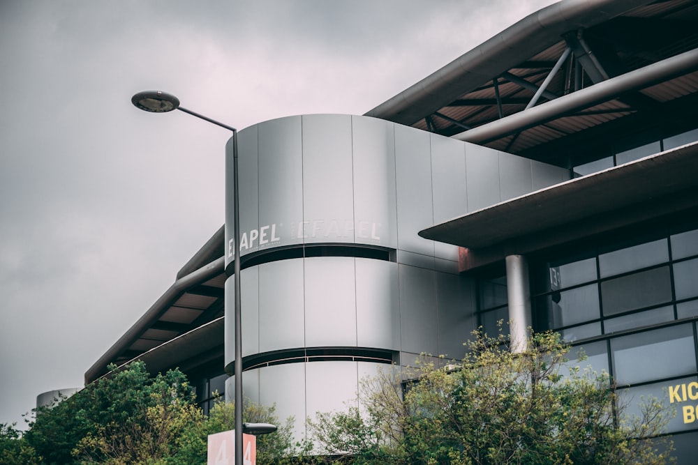 gray building near trees under gray sky