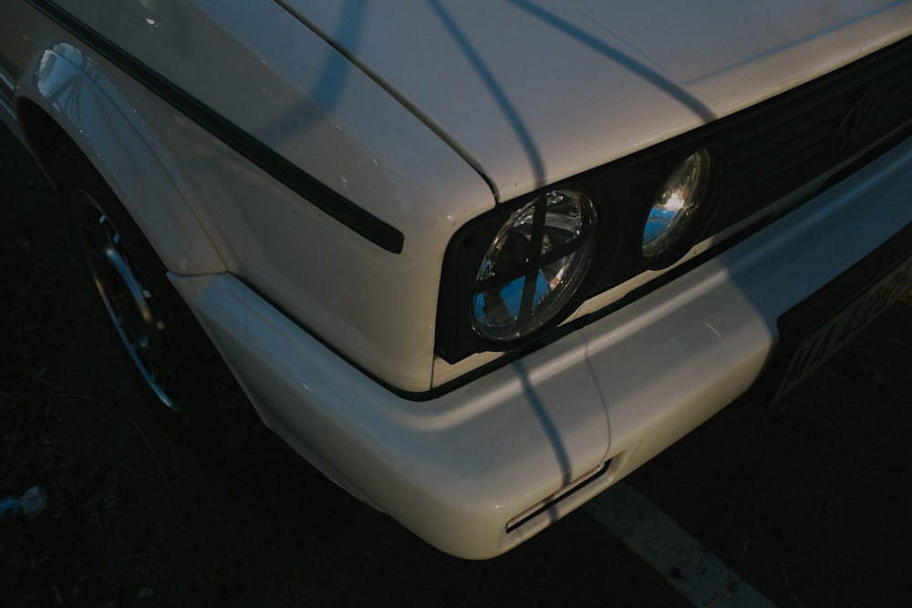 a close up of the front of a white car