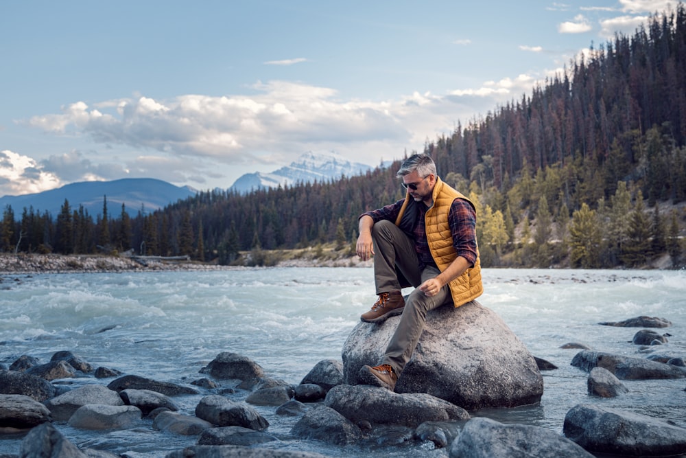 man sitting on rock