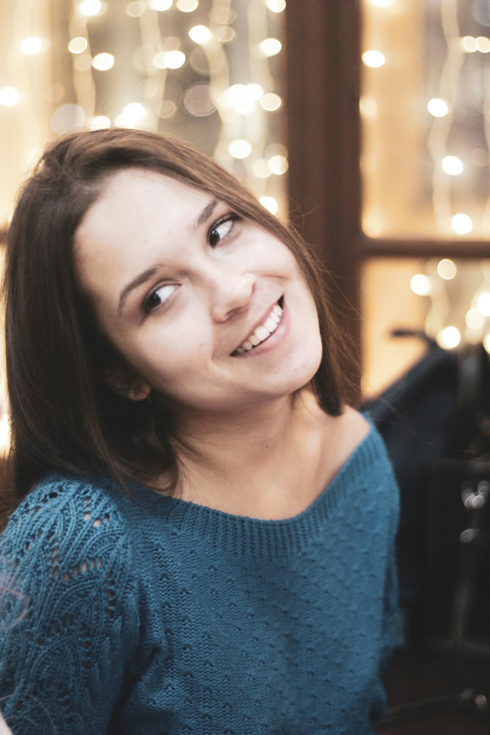 smiling woman in blue sweater