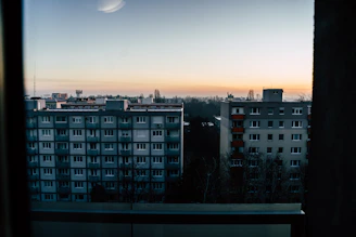 City skyline view with luxury apartment buildings at sunset.