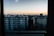 A cozy apartment with a beautiful view of the city skyline at sunset.