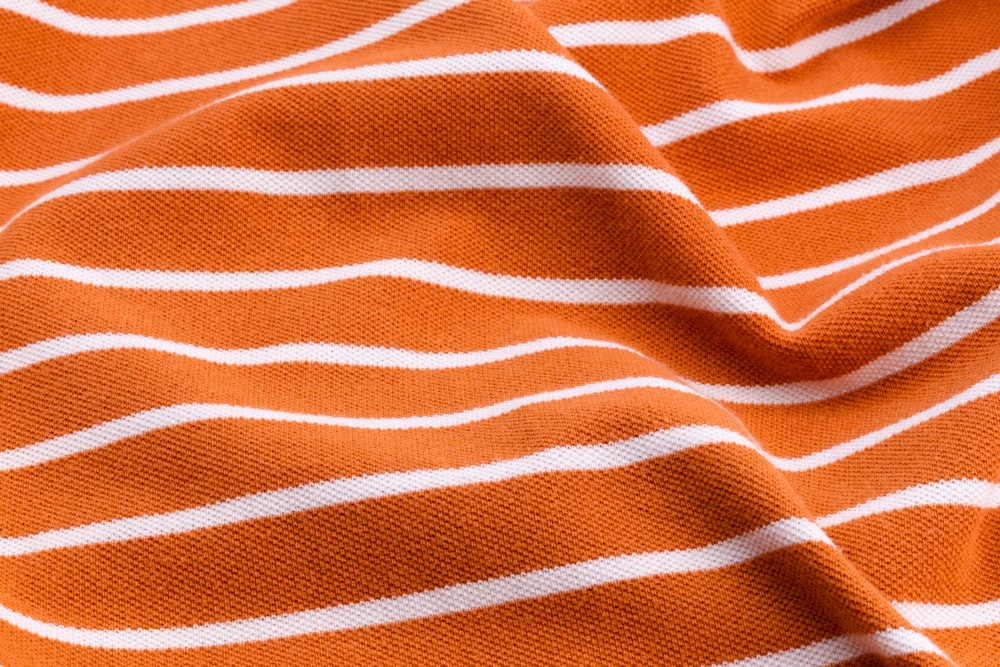 white and orange stripe textile