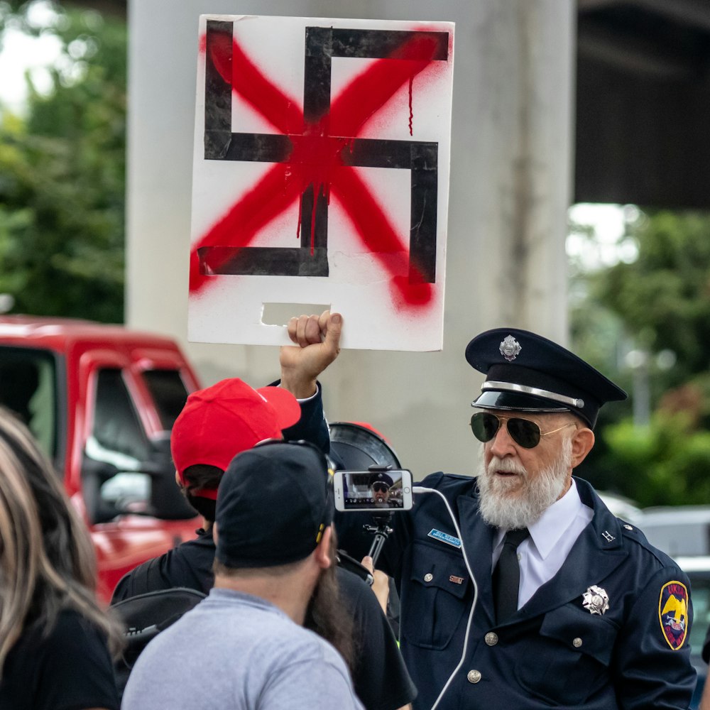 man holding swastika logo