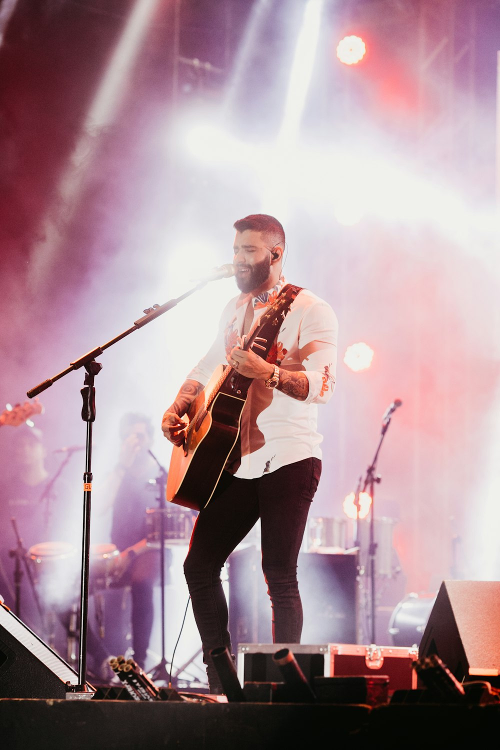 man playing guitar on stage