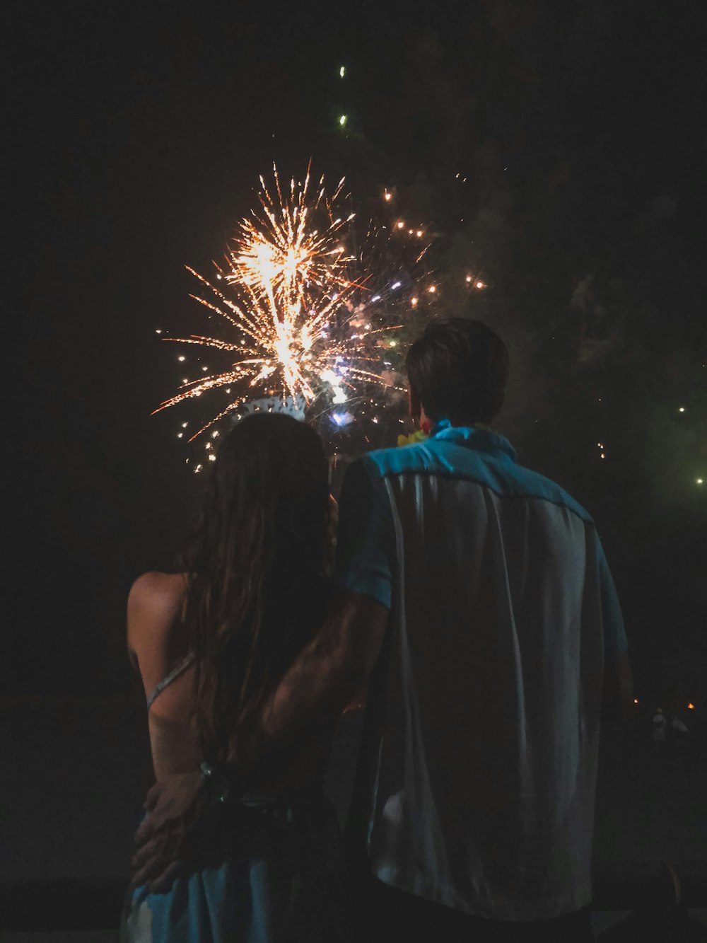 man holding waist of woman while watching fireworks