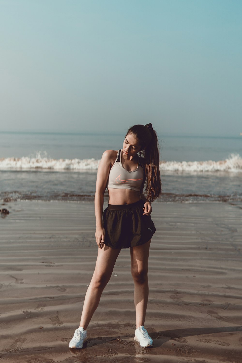 Woman in sport bra and shorts at beach photo – Free Grey Image on Unsplash