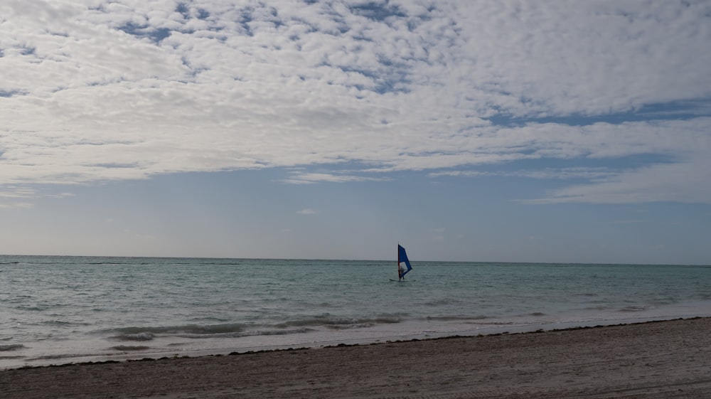 black sailboat on seashore