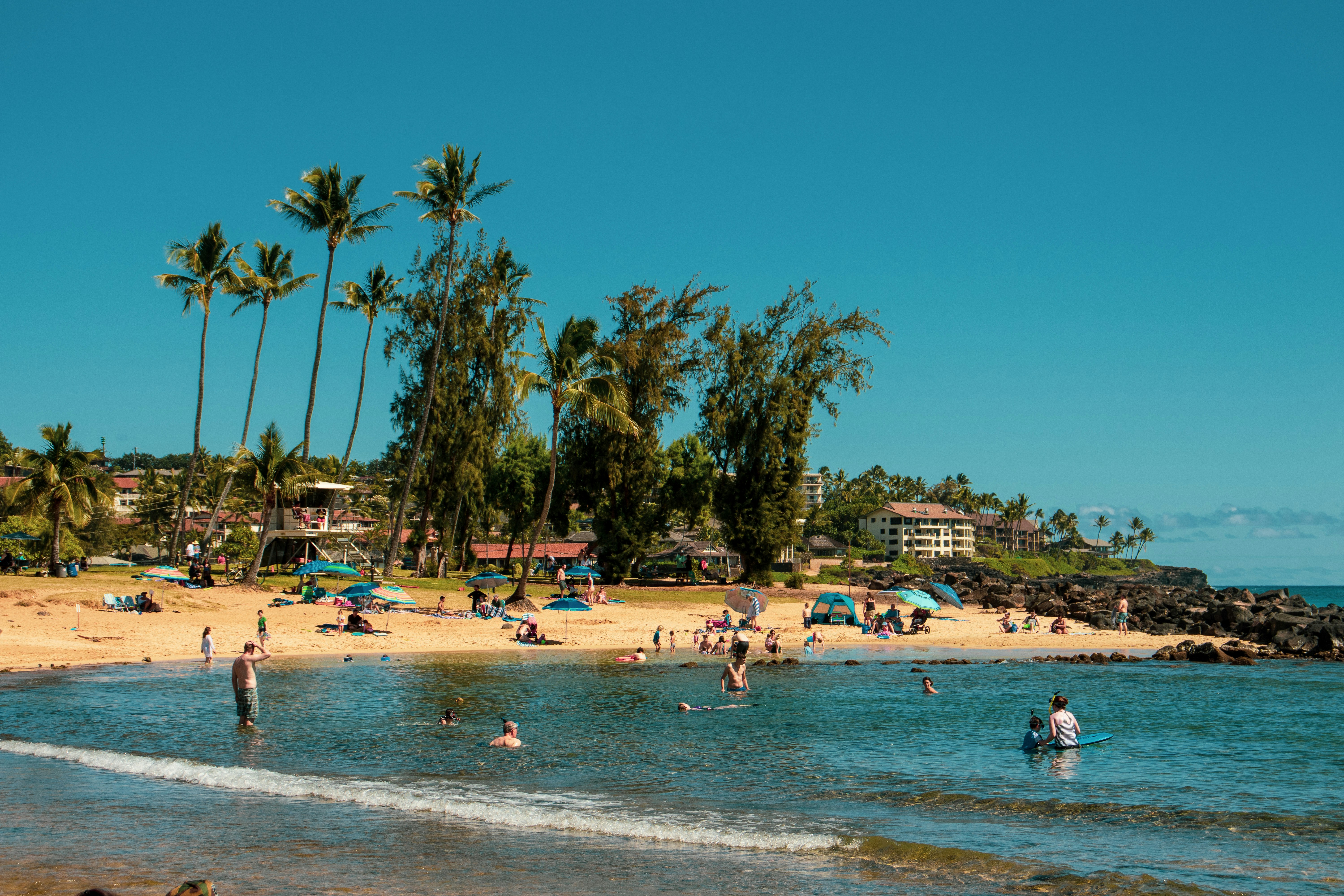 people standing and sitting on beach line, Another wonderful day at the beach