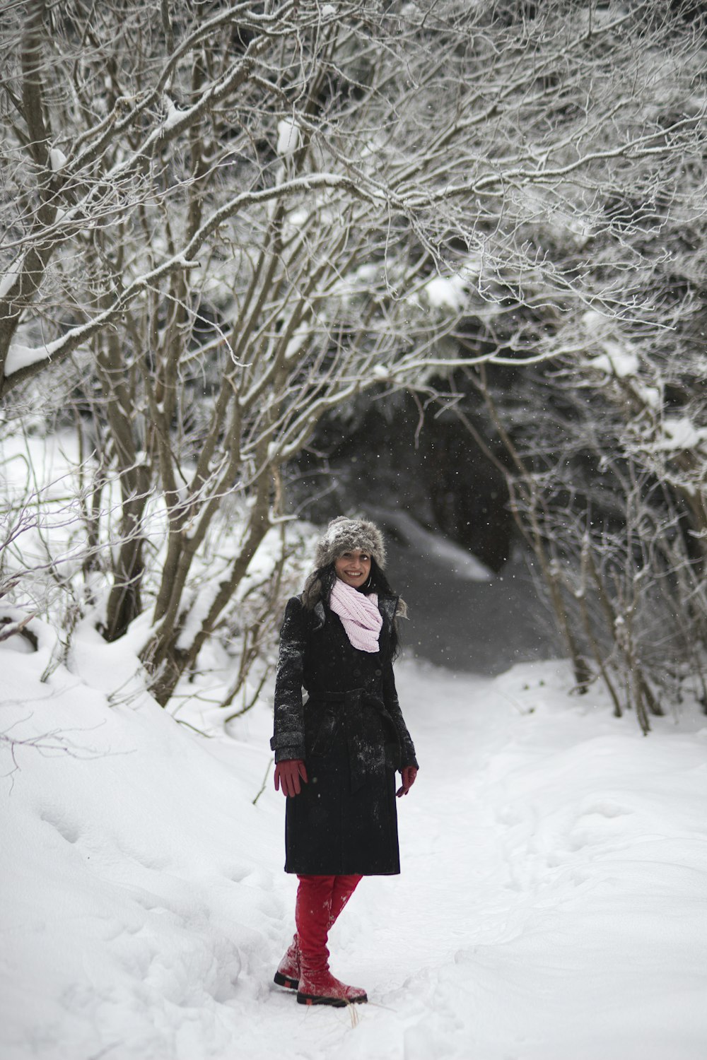 woman in black overcoat in snow
