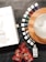 A collection of essential oil bottles are arranged in a semicircle on a wooden base next to a glass diffuser. There is a white box with branding and two red pouches labeled NingXia Red. A small bottle of hand purifier is placed nearby on a dark textured surface.