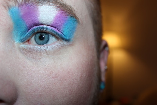 A person with trans flag eye makeup