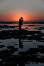 Portrait of Pablo Soto standing confidently by the San Carlos coastline during sunset.