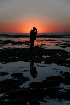 Portrait of Pablo Soto standing confidently by the San Carlos coastline during sunset.