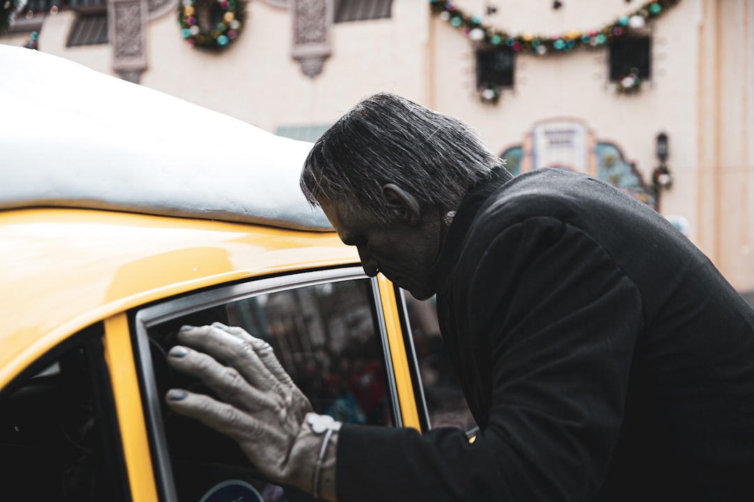 man looking inside car