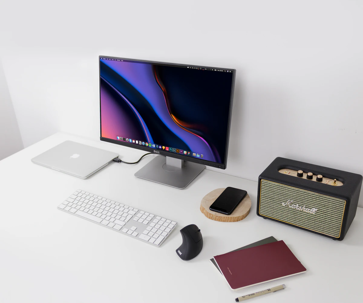 Modern desk setup with laptop, monitor and keyboard