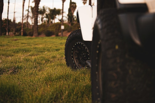 An influencer showcasing high-performance tires on a rugged off-road vehicle against a London cityscape backdrop.