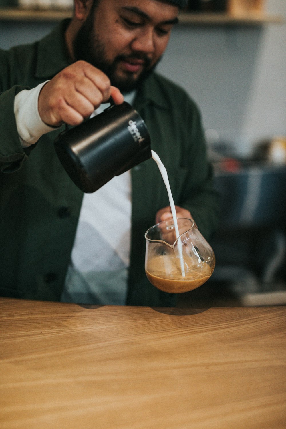 man pouring creamer in cup